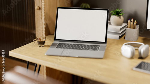 close-up image of minimal workspace with laptop mockup and decor on wood table