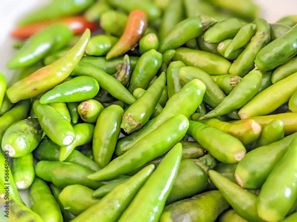 Defocused. Close-up. A pile of Green Chilies.  The results of the study stated that food mixed with green chilies can increase appetite. Cooking Concept 