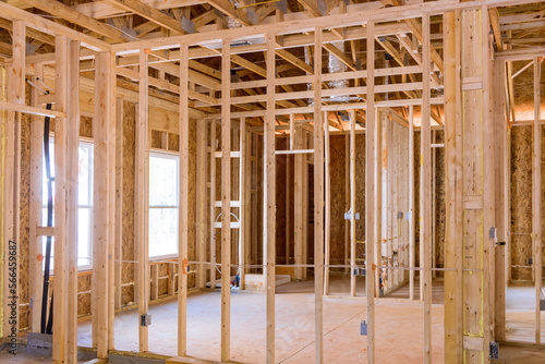 Wood frame unfinished for residential construction is framed by framing beams