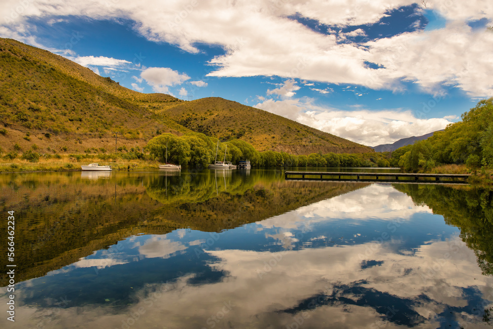 The crystal clear reflections on the beautiful serene little Boat Harbour at Sailors Cutting , Lake Benmore NZ