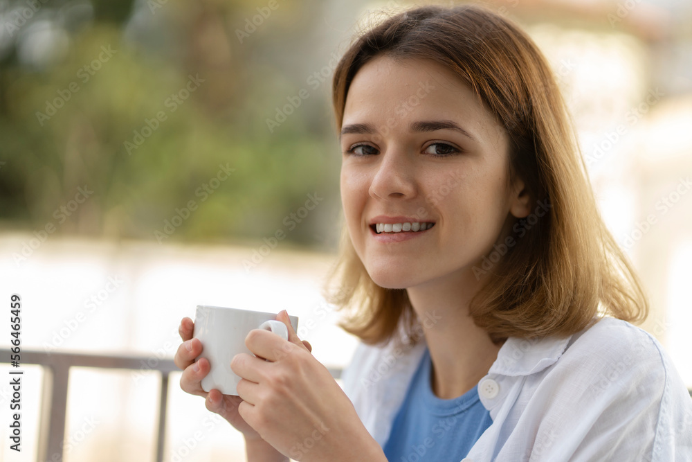 Beautiful smiling woman drinking coffee sitting in cafe. Morning coffee break concept Beautiful smiling woman drinking coffee sitting in cafe. Morning coffee break concept