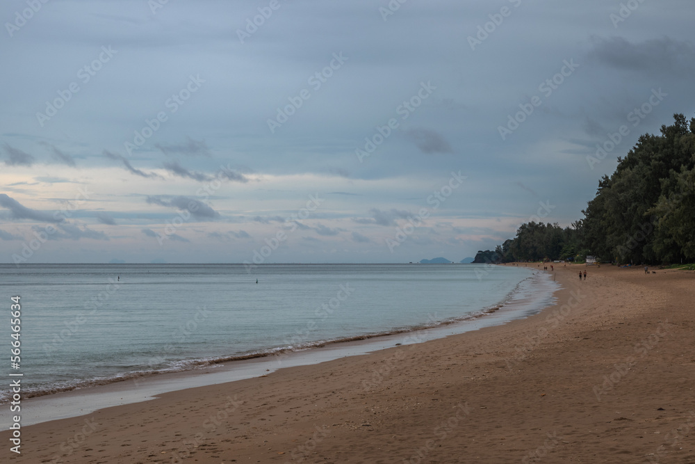 Long Beach, Koh Lanta, Thailand on a cloudy day with people on the beach