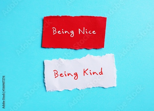 Torn paper on blue copy space background with handwriting BEING NICE, changed or BEING KIND, to stop being People Pleaser, prioritize self-respect and start being kind instead
