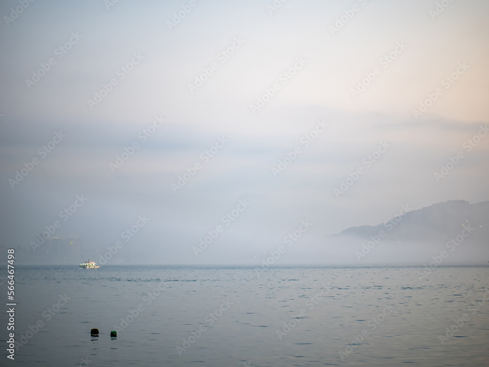 New Taipei City, Taiwan - JANUARY 14, 2023: Beautiful mist landscape of Tamsui on JANUARY 14,2023 in New Taipei City, Taiwan.It's popular sunset spot with visitors from Taipei.