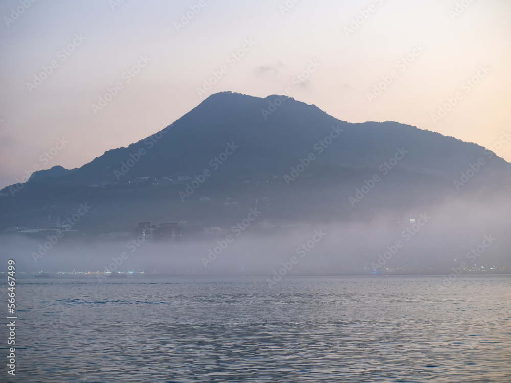mist mountains and river in evening in Tamsui, New Taipei City, Taiwan.
