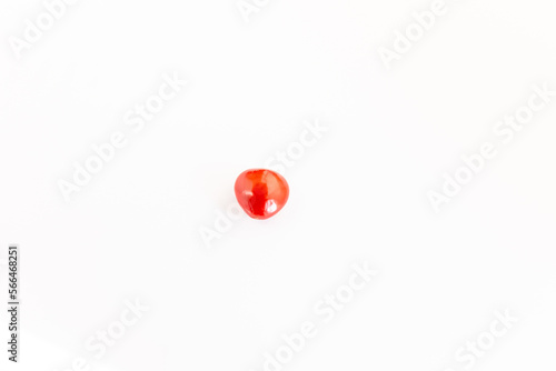 Ayurvedic plant Adenathera pavonina red seeds isolated on a white background