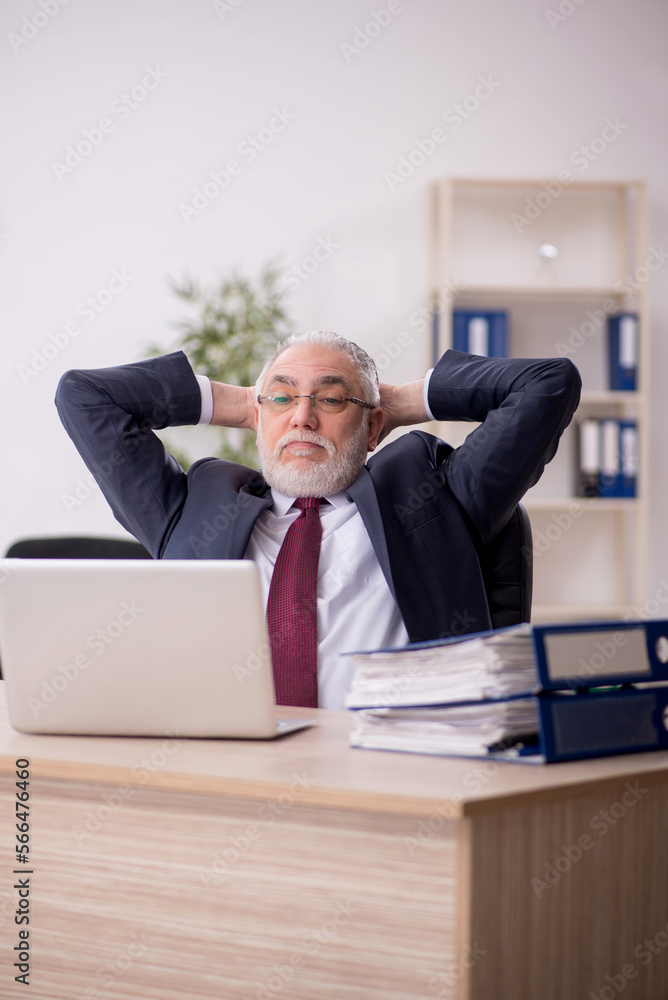 Old male employee and too much work in the office Old male employee and too much work in the office