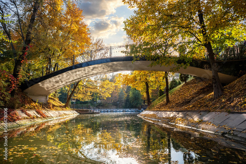 Picturesque bridge across the autumn lake in Almaty Gorky Park, Kazakhstan. © Roman