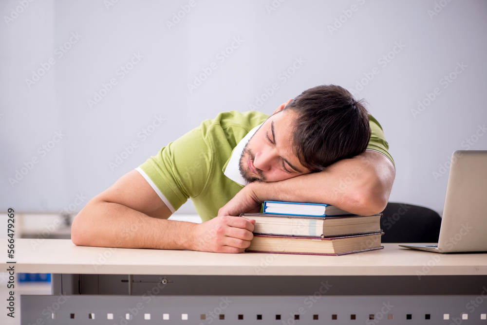 Young male teacher student in the classroom Young male teacher student in the classroom