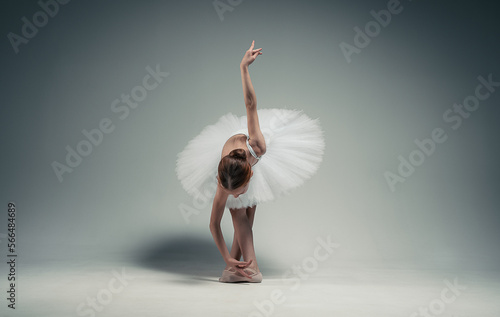 young ballerina girl makes a bow. on a white background.