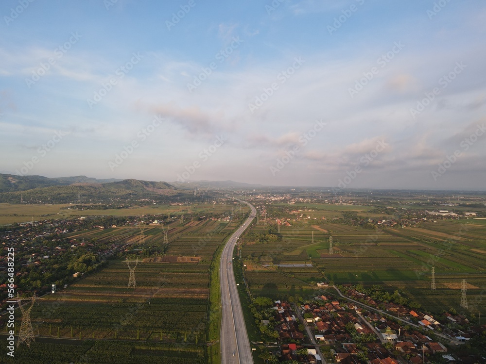 Aerial view of Jalan Raya Indonesia with few cars and sunrise view