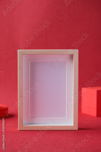 blank mockup photo freame with display block at red background studio photo