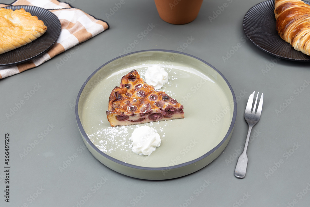 Clafoutis with cream on a plate