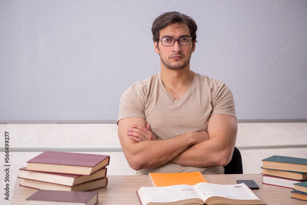 Young male student sitting in the classroom Young male student sitting in the classroom