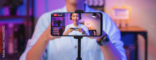 Quadro em tela Vlogger live streaming podcast review on social media, Young Asian woman use microphones wear headphones with smartphone record video