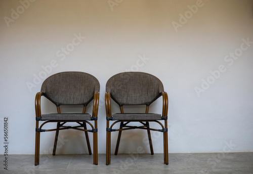 Two brown chairs are placed next to each other against a white background. except copy space