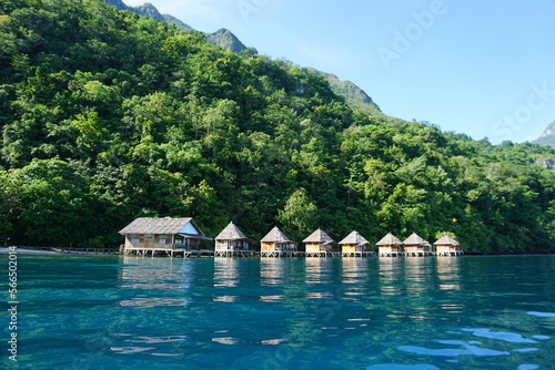 Obraz na plátne A row of traditional stilt houses above the beautiful Ora Beach with its green s