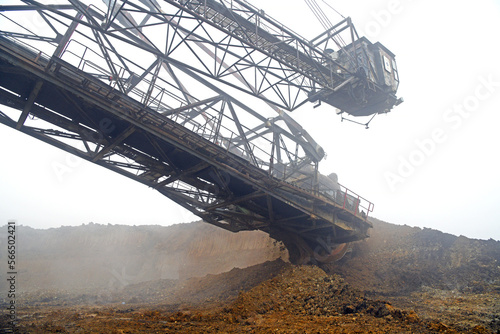 Bucket-wheel excavator during excavation at the surface mine. Huge excavator on open pit mine.