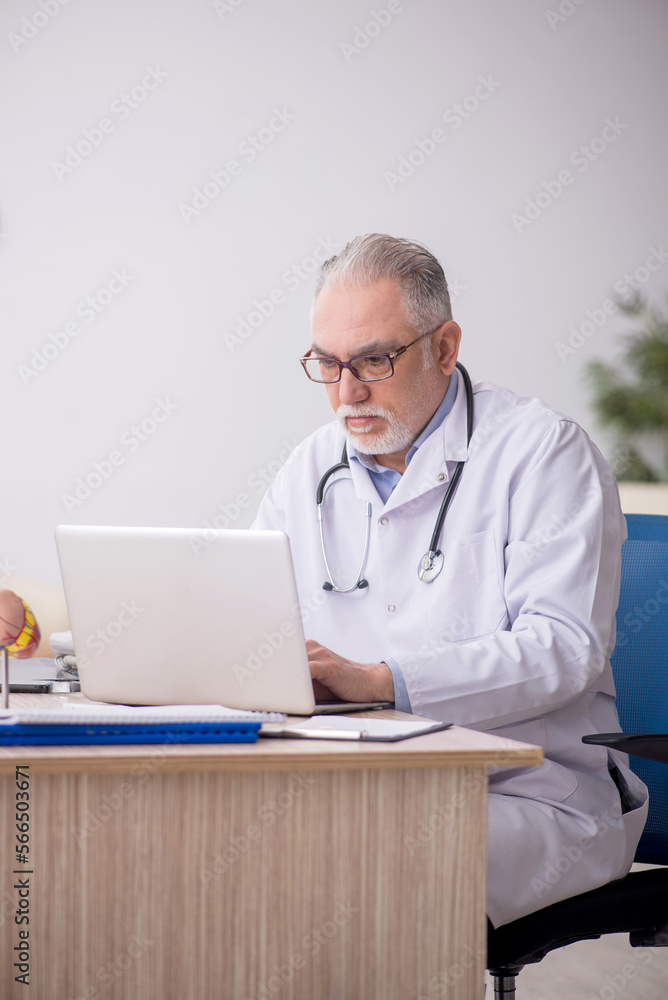 Old male doctor in telemedicine concept Old male doctor in telemedicine concept