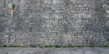 ancient grey tile stone wall in street city background of house facade gray stones wallpaper
