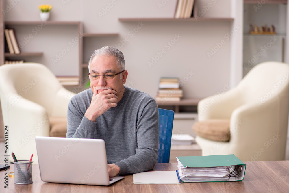 Old male employee working from home during pandemic Old male employee working from home during pandemic