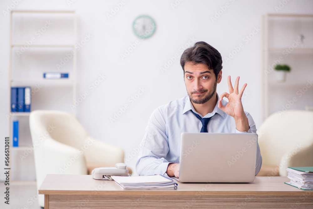 Young male employee working in the office Young male employee working in the office
