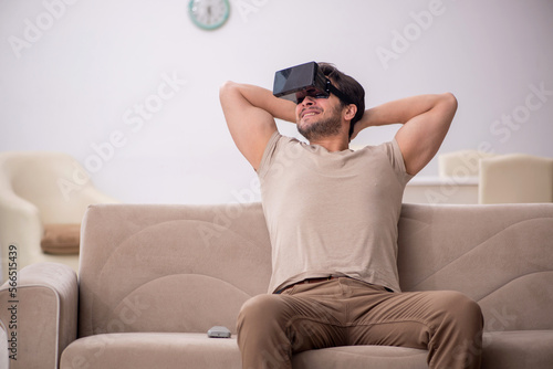 Young man enjoying virtual reality at home