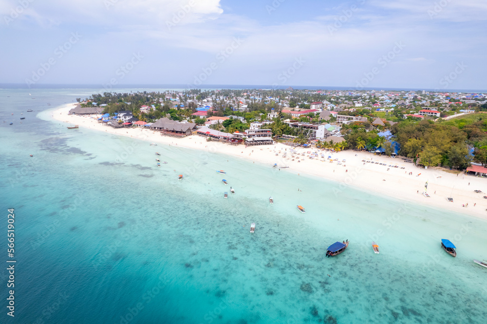 Aerial Shot on Zanzibar a beautiful sunset with people Walking on the Nungwi beach in Zanzibar in Tanzania