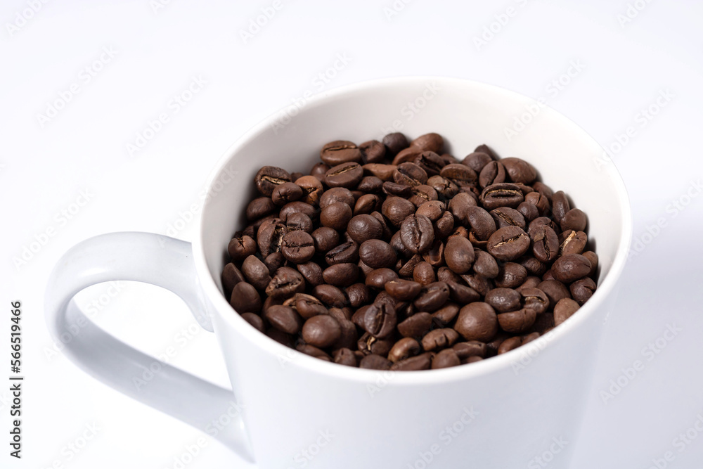 top of mug full of coffee beans on white background close up horizontal photo top of mug full of coffee beans on white background close up horizontal photo