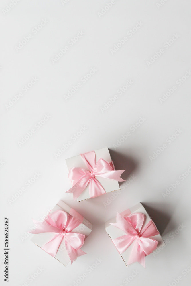 Three gift boxes with pink satin ribbon, isolated on white background Three gift boxes with pink satin ribbon, isolated on white background