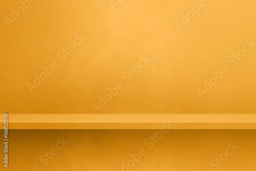 Empty shelf on a yellow gold concrete wall. Background template. Horizontal mockup