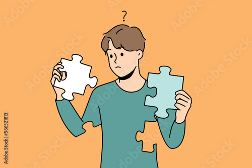Frustrated young man with jigsaw puzzles in hands rebuild personality. Concept of mental and psychological disorder. Psychology treatment and recovery. Vector illustration. 