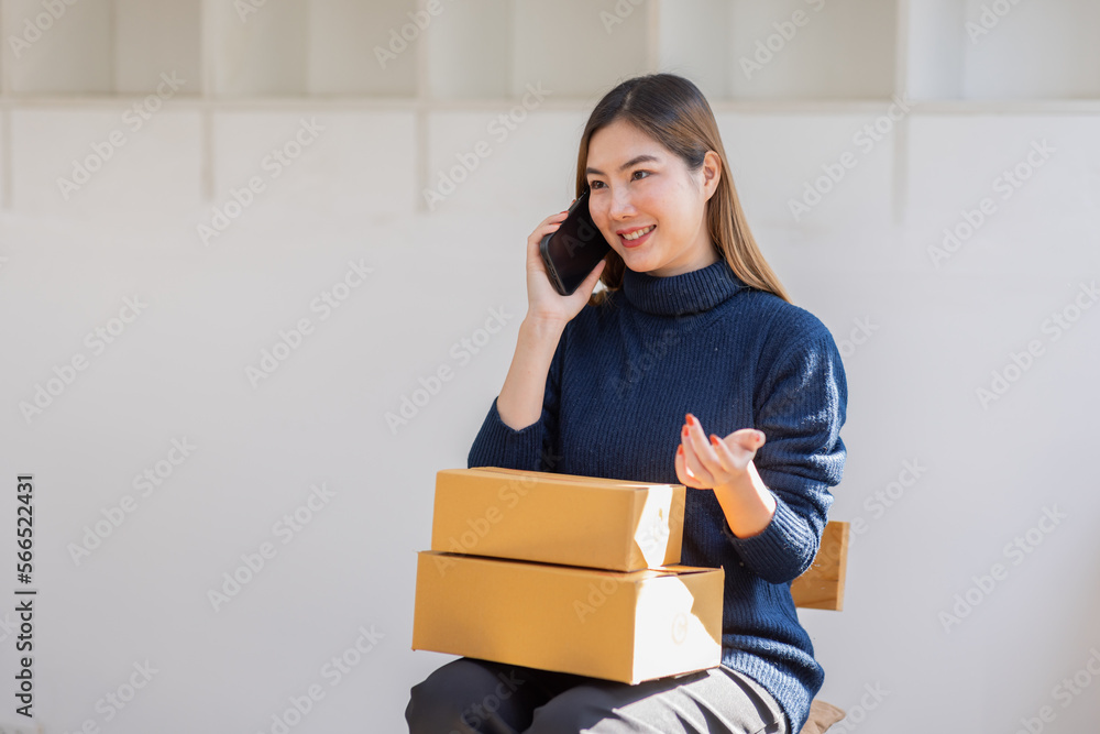 Startup SME small business entrepreneur of freelance Asian woman call phone with box white background, Cheerful success Asian woman online marketing packaging box and delivery SME idea concept Startup SME small business entrepreneur of freelance Asian woman call phone with box white background, Cheerful success Asian woman online marketing packaging box and delivery SME idea concept