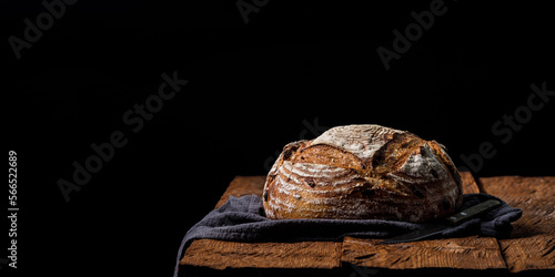 Rustic crispy sourdough bread with cranberries on a wooden table. Panoramic view, free space for text