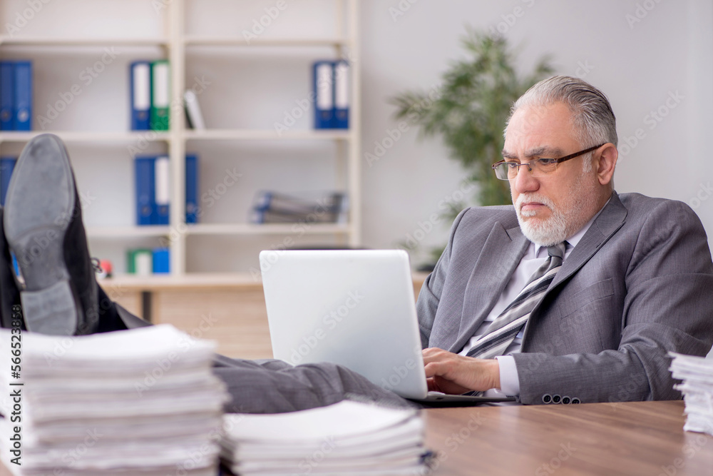 Old male employee and too much work in the office Old male employee and too much work in the office