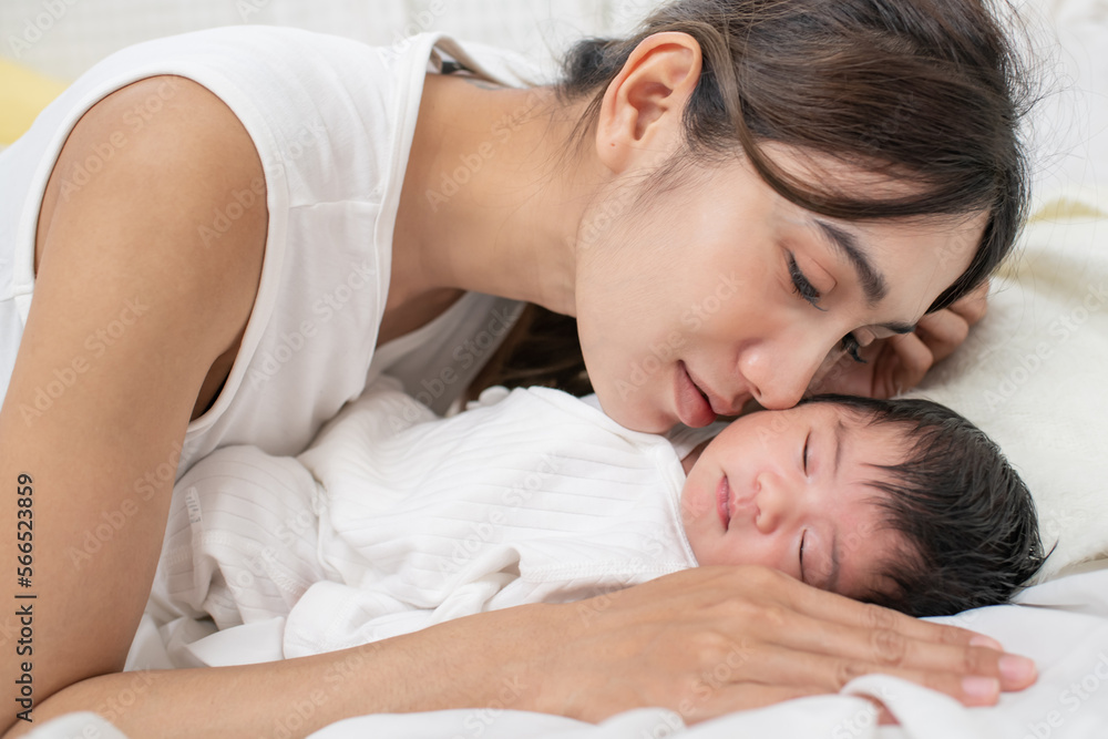 happy loving family. mother playing with her baby hugging in the bedroom , portrait of asian mother playing with newborn baby, health care family love together. asian girl lifestyle.. happy loving family. mother playing with her baby hugging in the bedroom , portrait of asian mother playing with newborn baby, health care family love together. asian girl lifestyle..