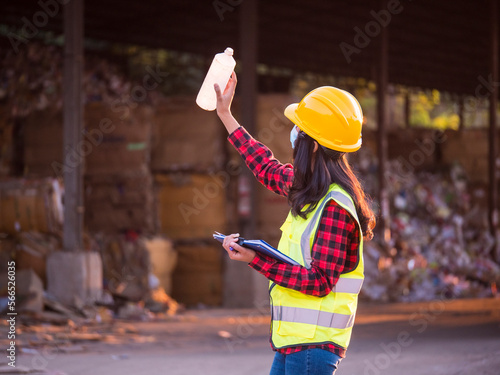 Fotografie Worker holding a plastic bottle At recycling waste sorting plant, worker checkin