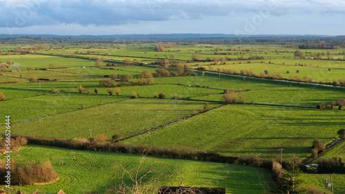 Rural English countryside landscape view of green agriculture farmland fields of the Somerset Levels in Glastonbury, Somerset, England