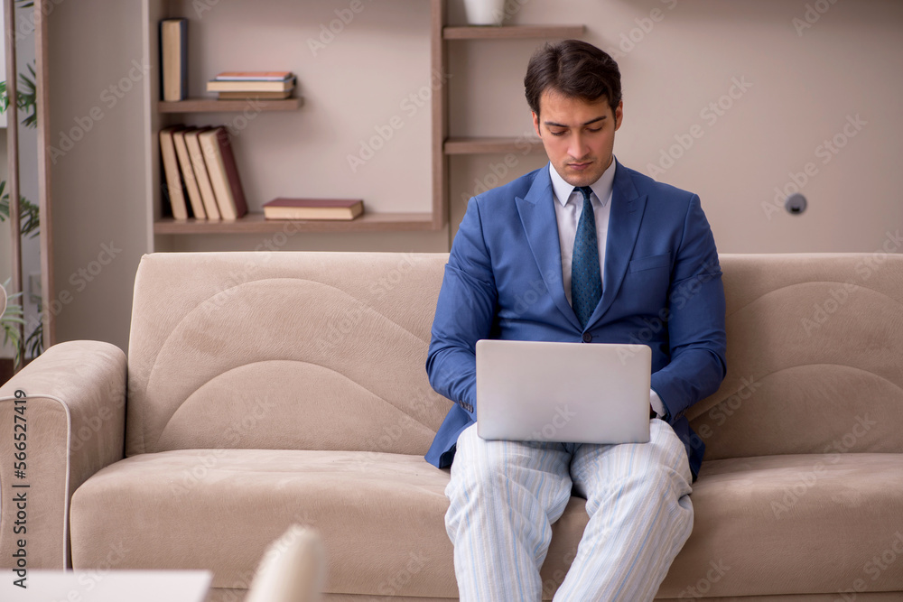 Young male employee working from home during pandemic Young male employee working from home during pandemic