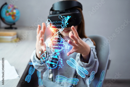 Schoolgirl is using virtual reality simulator headset for study. Child is wearing virtual reality glasses sits at desk and touches 3d model of DNA molecule. Future learning concept