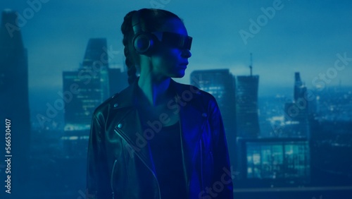 Wallpaper Mural Portrait of cyberpunk girl with a smartphone in a glasses and headphones. Beautiful young woman on the background of city scyscrapers. Torontodigital.ca