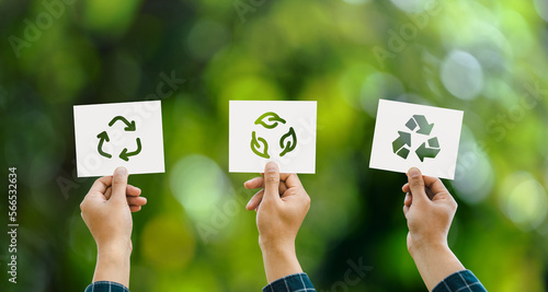 Hand holding recycle symbol 3 different icons on green bokeh background. eco concept and save the world environment photo