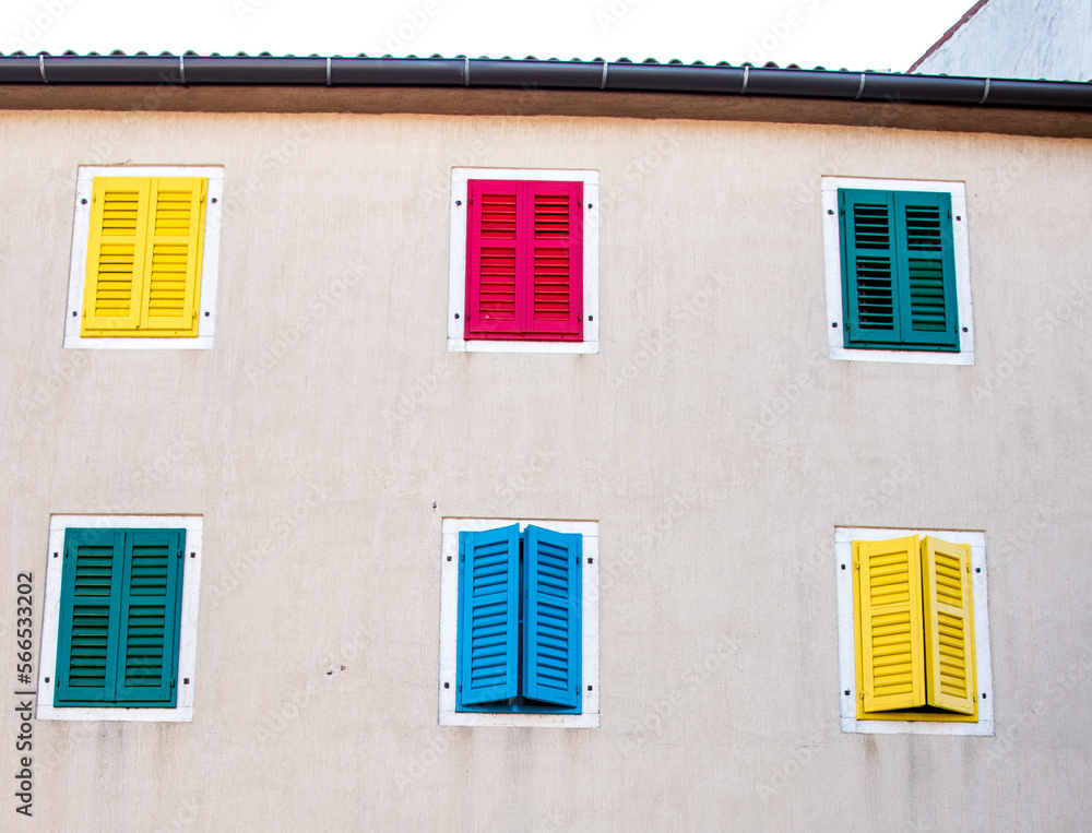 An interesting house with colored shutters.