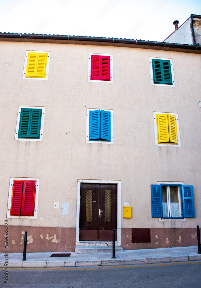 An interesting house with colored shutters.