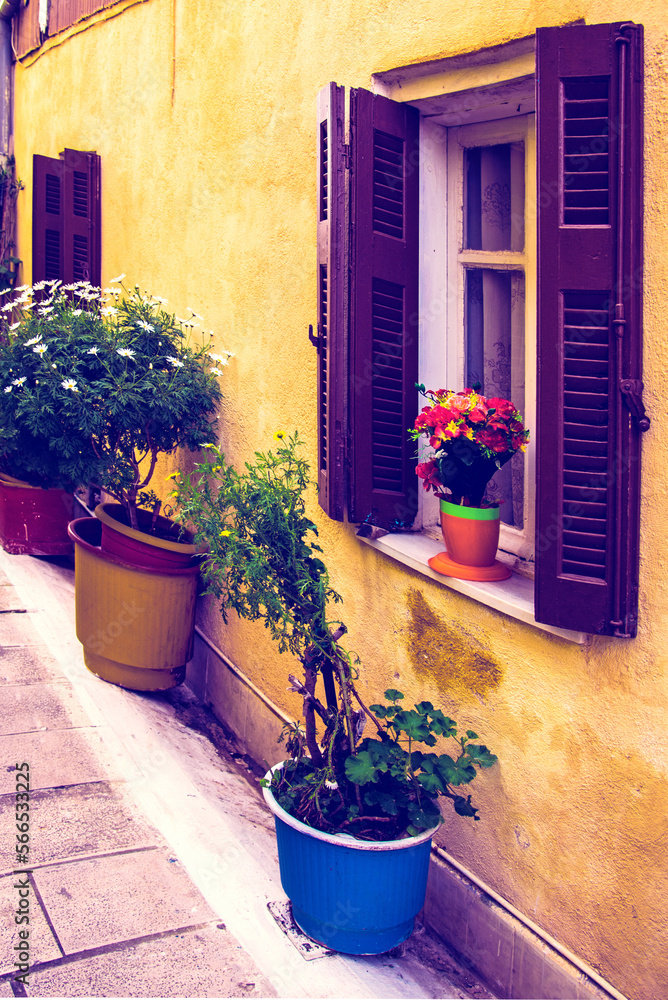 Bright colorful optimistic street view on the waterfront in the capital of the island of Lefkada, Greece with flower vases. popular tourist attractions. amazing places.