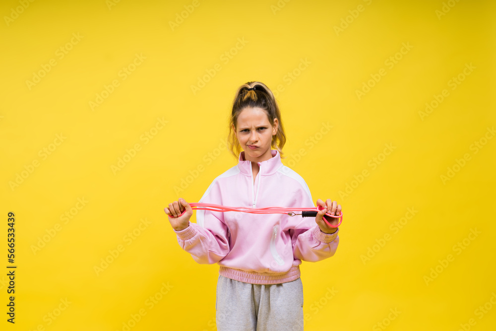 Adorable female child with skipping rope jumping in studio Adorable female child with skipping rope jumping in studio