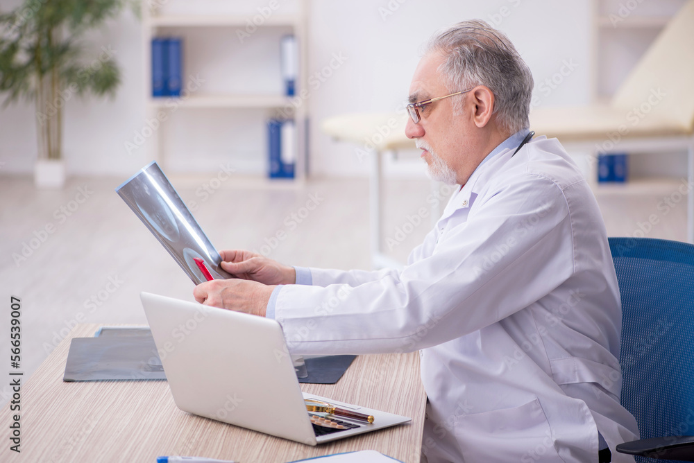 Old male doctor radiologist working in the clinic Old male doctor radiologist working in the clinic