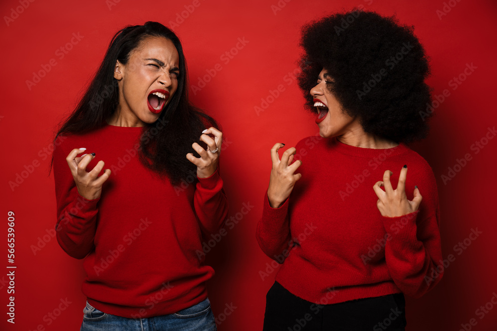 Two women expressing excitement and gesturing with tense hands Two women expressing excitement and gesturing with tense hands