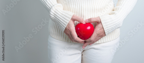 Woman holding  red heart shape. Pregnancy, Reproductive system, menstruation, and gynecology concept photo