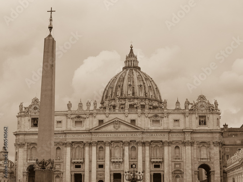 View from the street Via della Conciliazione to the Vatican City with Vatican Obelisk and famous St. Peter's Basilica in the St. Peter's Square. Rome, Italy. Black and white sepia tone photography. photo